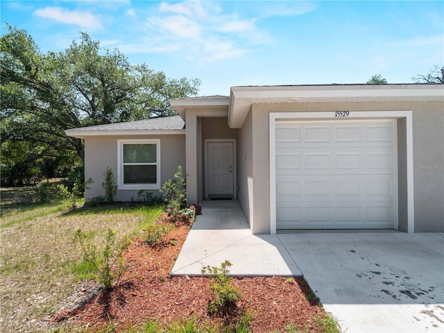 15579/15581 Chamberlain Blvd, Port Charlotte, FL 33953 - ranch-style house with concrete driveway, stucco siding, and an attached garage