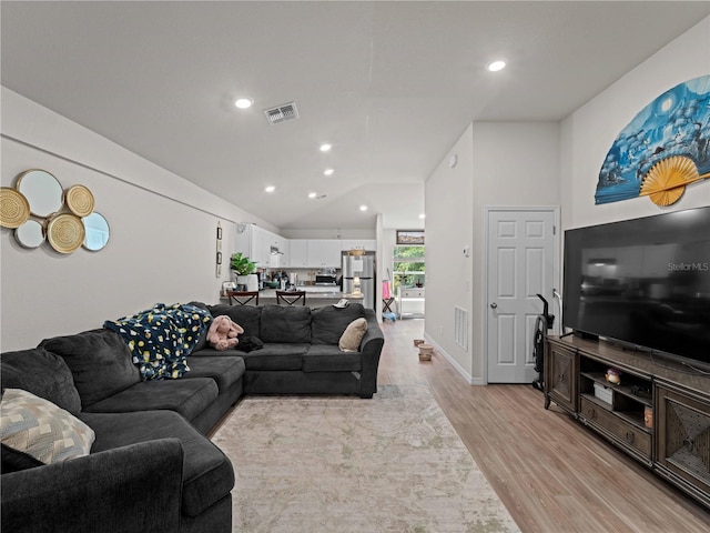 15579/15581 Chamberlain Blvd, Port Charlotte, FL 33953 - living area featuring recessed lighting, visible vents, vaulted ceiling, and light wood-style floors
