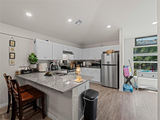 15579/15581 Chamberlain Blvd, Port Charlotte, FL 33953 - kitchen with a sink, stainless steel appliances, a peninsula, under cabinet range hood, and visible vents