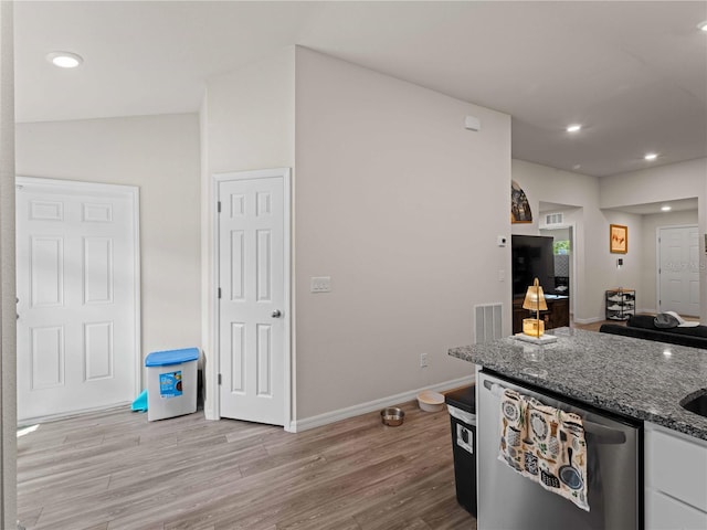 15579/15581 Chamberlain Blvd, Port Charlotte, FL 33953 - kitchen featuring white cabinets, baseboards, stone counters, light wood-type flooring, and stainless steel dishwasher