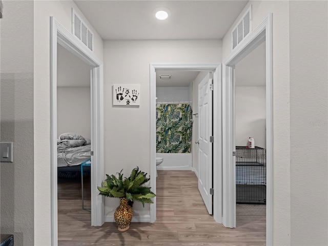15579/15581 Chamberlain Blvd, Port Charlotte, FL 33953 - corridor featuring visible vents and wood finished floors