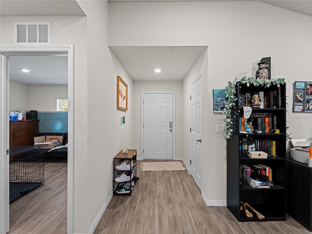 15579/15581 Chamberlain Blvd, Port Charlotte, FL 33953 - hallway with baseboards, visible vents, and wood finished floors
