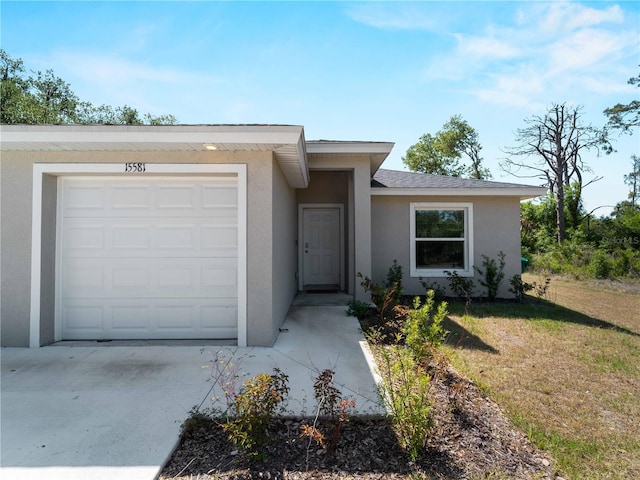 15579/15581 Chamberlain Blvd, Port Charlotte, FL 33953 - single story home featuring a garage, stucco siding, driveway, and a front yard
