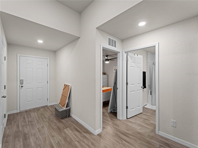 15579/15581 Chamberlain Blvd, Port Charlotte, FL 33953 - corridor with visible vents, light wood finished floors, and baseboards