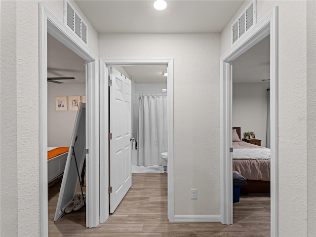 15579/15581 Chamberlain Blvd, Port Charlotte, FL 33953 - hall featuring a textured wall, visible vents, and wood finished floors