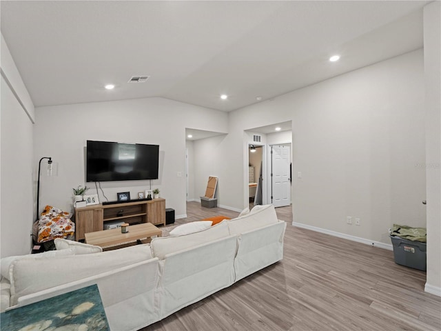 15579/15581 Chamberlain Blvd, Port Charlotte, FL 33953 - living area featuring baseboards, vaulted ceiling, light wood finished floors, and visible vents