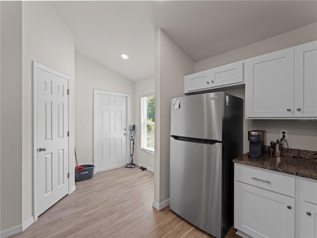 15579/15581 Chamberlain Blvd, Port Charlotte, FL 33953 - kitchen with freestanding refrigerator, lofted ceiling, baseboards, light wood-type flooring, and white cabinets