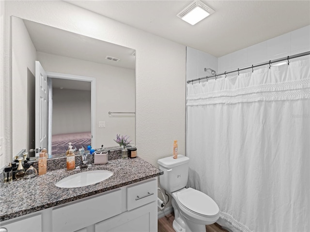 15579/15581 Chamberlain Blvd, Port Charlotte, FL 33953 - bathroom featuring visible vents, curtained shower, wood finished floors, vanity, and toilet