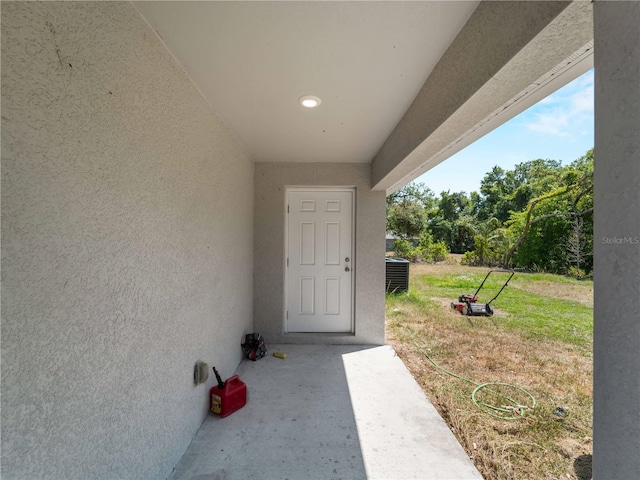 15579/15581 Chamberlain Blvd, Port Charlotte, FL 33953 - property entrance featuring central air condition unit, a yard, and stucco siding