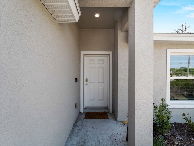 15579/15581 Chamberlain Blvd, Port Charlotte, FL 33953 - view of exterior entry featuring visible vents and stucco siding