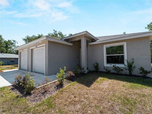 15579/15581 Chamberlain Blvd, Port Charlotte, FL 33953 - ranch-style house featuring a garage, a front lawn, stucco siding, and concrete driveway
