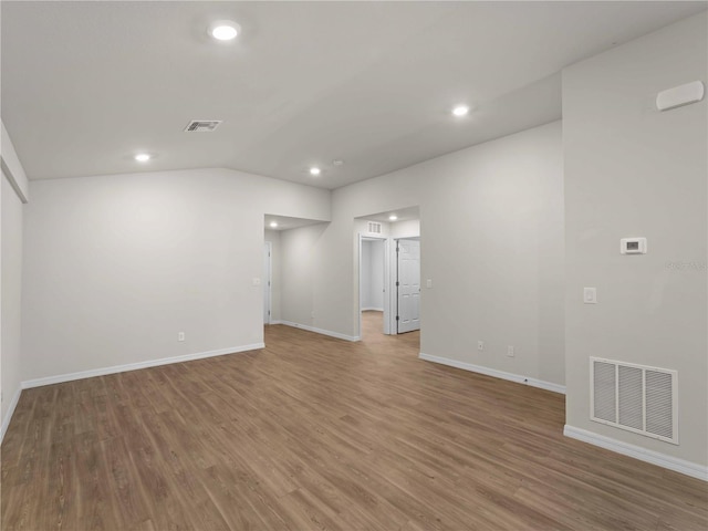 17190/17192 Nixon Ave, Port Charlotte, FL 33948 - empty room featuring recessed lighting, baseboards, wood finished floors, vaulted ceiling, and visible vents