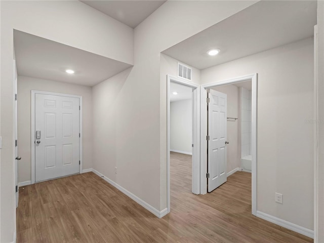 17190/17192 Nixon Ave, Port Charlotte, FL 33948 - hall featuring visible vents, baseboards, and wood finished floors
