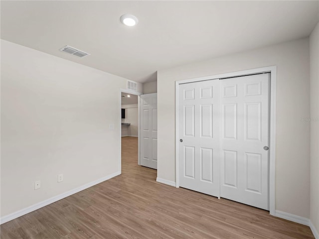 17190/17192 Nixon Ave, Port Charlotte, FL 33948 - unfurnished bedroom with baseboards, visible vents, and light wood-type flooring