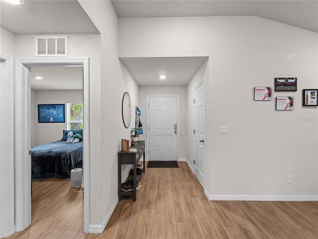 17190/17192 Nixon Ave, Port Charlotte, FL 33948 - entryway featuring baseboards, vaulted ceiling, light wood-type flooring, and visible vents