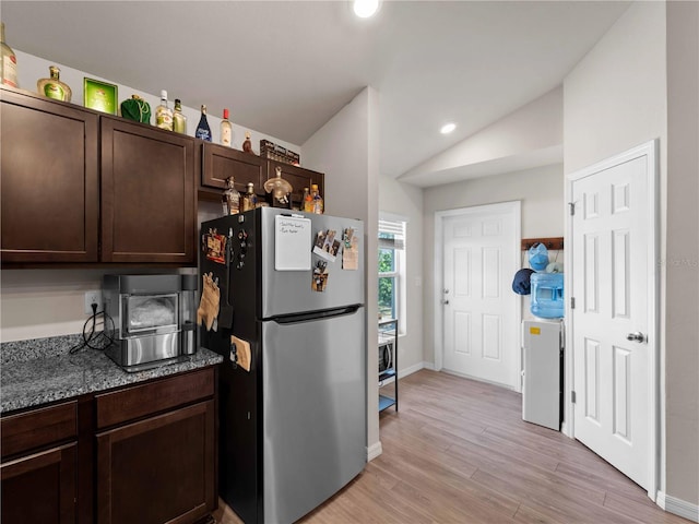 17190/17192 Nixon Ave, Port Charlotte, FL 33948 - kitchen with dark brown cabinetry, light wood-style flooring, freestanding refrigerator, recessed lighting, and lofted ceiling