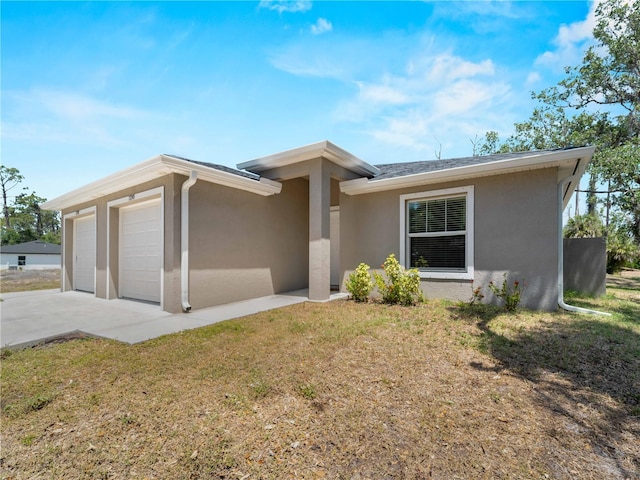 17190/17192 Nixon Ave, Port Charlotte, FL 33948 - view of front facade featuring a garage, stucco siding, driveway, and a front lawn