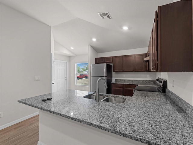 17190/17192 Nixon Ave, Port Charlotte, FL 33948 - kitchen featuring visible vents, a sink, light stone counters, a peninsula, and stainless steel appliances