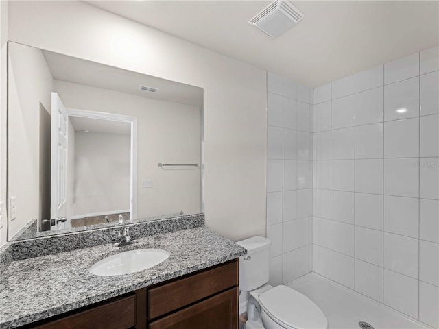17190/17192 Nixon Ave, Port Charlotte, FL 33948 - bathroom with visible vents, a tile shower, toilet, and vanity