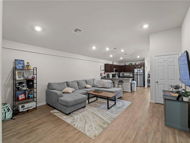 17190/17192 Nixon Ave, Port Charlotte, FL 33948 - living area with light wood-style floors, vaulted ceiling, recessed lighting, and visible vents