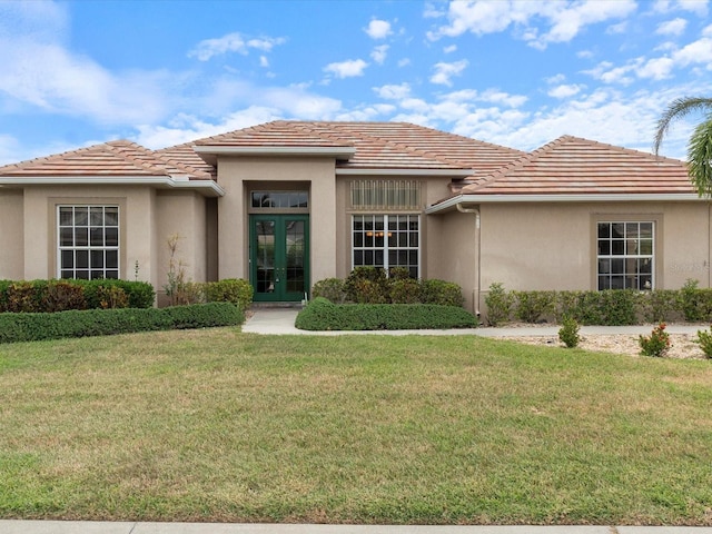 857 Macaw Cir, Venice, FL 34285 - view of front of home featuring stucco siding, french doors, and a front yard