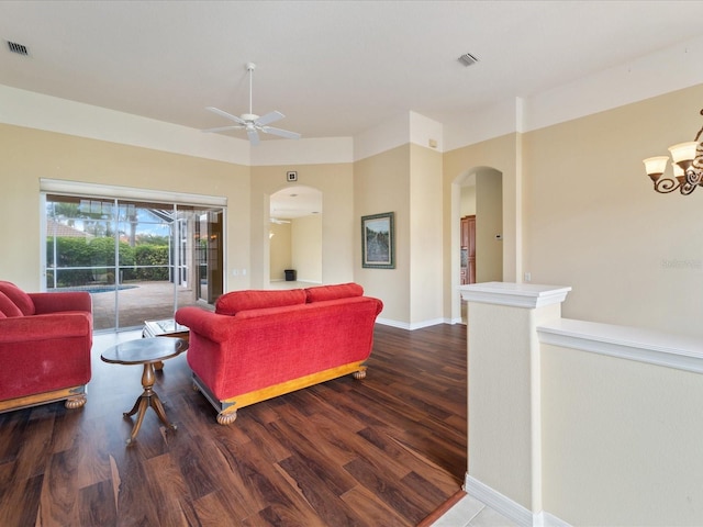 857 Macaw Cir, Venice, FL 34285 - living area with arched walkways, wood finished floors, visible vents, and ceiling fan with notable chandelier