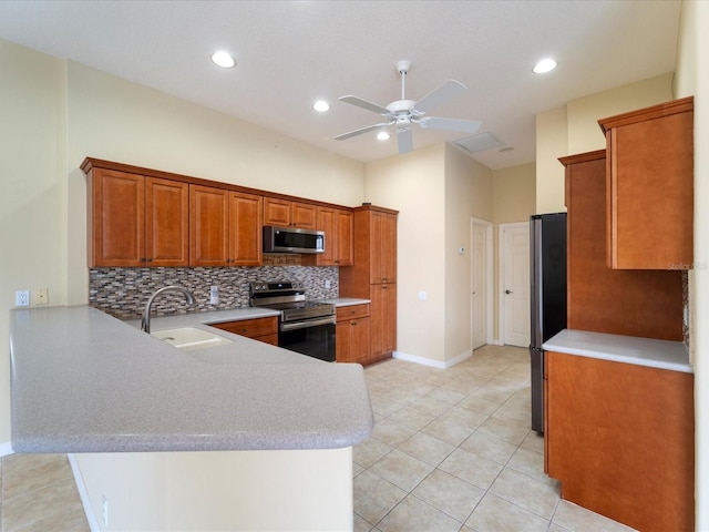 857 Macaw Cir, Venice, FL 34285 - kitchen featuring a sink, a peninsula, light countertops, and appliances with stainless steel finishes