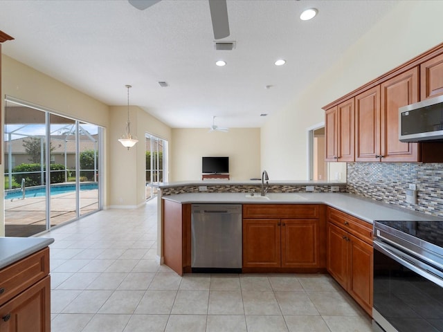 857 Macaw Cir, Venice, FL 34285 - kitchen with a ceiling fan, a sink, open floor plan, stainless steel appliances, and tasteful backsplash