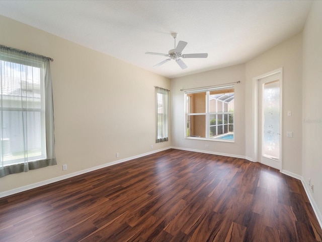 857 Macaw Cir, Venice, FL 34285 - unfurnished room with baseboards, a wealth of natural light, dark wood finished floors, and ceiling fan