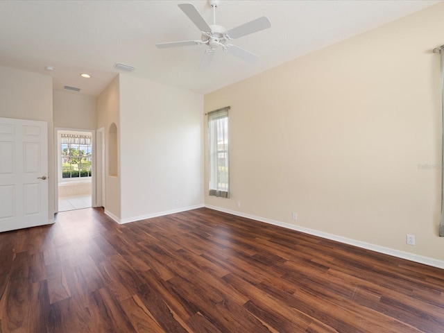 857 Macaw Cir, Venice, FL 34285 - empty room featuring a ceiling fan, visible vents, baseboards, dark wood-type flooring, and arched walkways