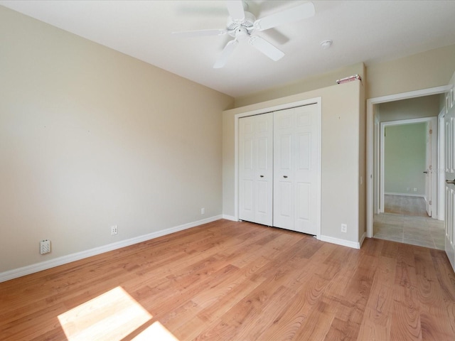 857 Macaw Cir, Venice, FL 34285 - unfurnished bedroom with a closet, light wood-type flooring, baseboards, and ceiling fan