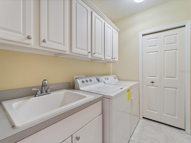 857 Macaw Cir, Venice, FL 34285 - laundry area featuring a sink, cabinet space, washing machine and dryer, and light tile patterned floors