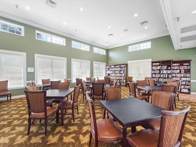 857 Macaw Cir, Venice, FL 34285 - carpeted dining area featuring visible vents, recessed lighting, crown molding, a high ceiling, and baseboards