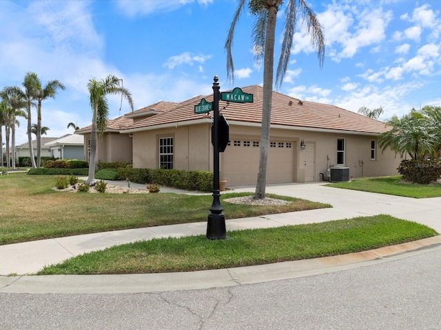 857 Macaw Cir, Venice, FL 34285 - single story home featuring a tiled roof, a garage, concrete driveway, central AC unit, and a front yard