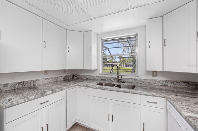 261 Caddy Rd, Rotonda West, FL 33947 - kitchen with white dishwasher and white cabinetry