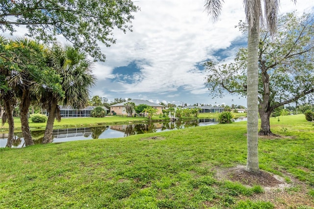 261 Caddy Rd, Rotonda West, FL 33947 - view of green lawn with a water view and a residential view