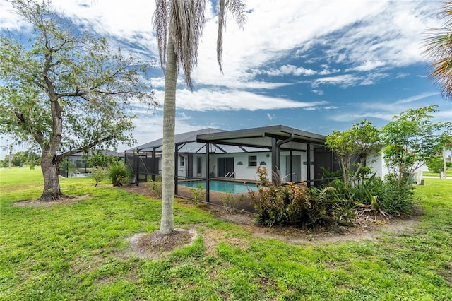 261 Caddy Rd, Rotonda West, FL 33947 - rear view of house featuring an outdoor pool, a lanai, and a yard