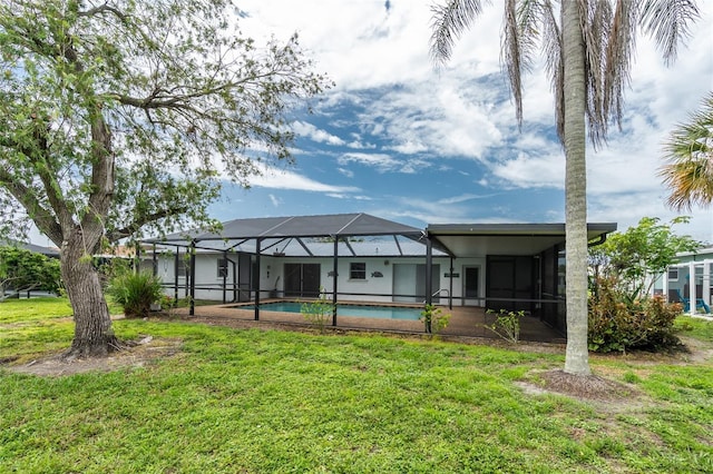 261 Caddy Rd, Rotonda West, FL 33947 - back of property featuring a yard, an outdoor pool, and glass enclosure