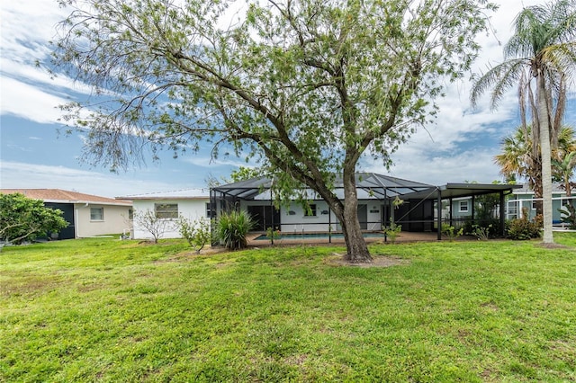261 Caddy Rd, Rotonda West, FL 33947 - back of property with a yard, an outdoor pool, and a lanai