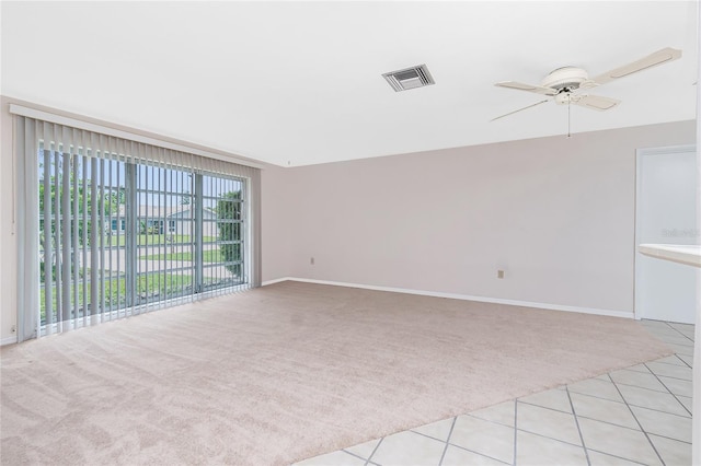 261 Caddy Rd, Rotonda West, FL 33947 - unfurnished room with light colored carpet, ceiling fan, and light tile patterned floors