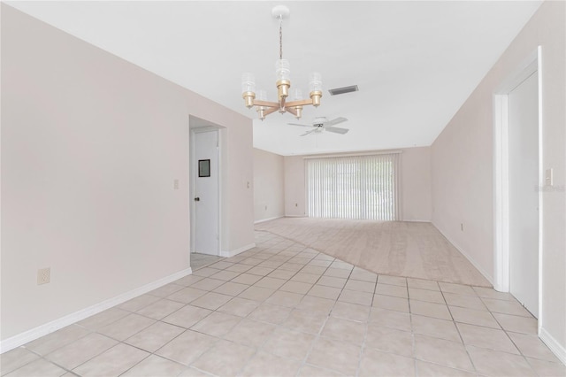 261 Caddy Rd, Rotonda West, FL 33947 - spare room featuring a chandelier, ceiling fan, light tile patterned flooring, and light carpet