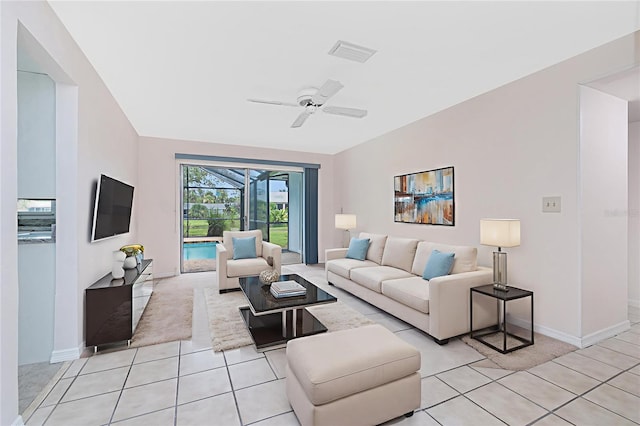 261 Caddy Rd, Rotonda West, FL 33947 - living room featuring a sunroom, a ceiling fan, and light tile patterned floors