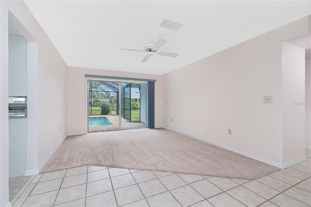 261 Caddy Rd, Rotonda West, FL 33947 - spare room with light colored carpet, ceiling fan, a sunroom, and light tile patterned flooring