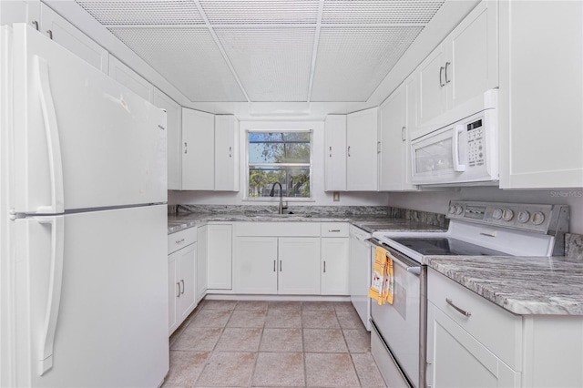 261 Caddy Rd, Rotonda West, FL 33947 - kitchen with white appliances, white cabinets, and light stone counters