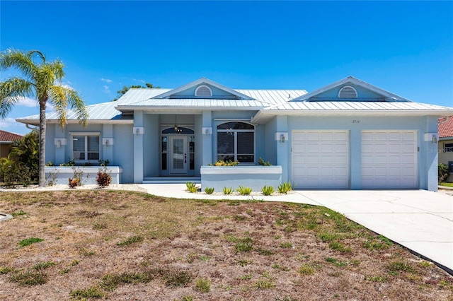 1711 Boca Raton Ct, Punta Gorda, FL 33950 - single story home with driveway, a standing seam roof, metal roof, a garage, and stucco siding