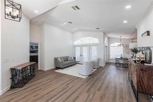 1711 Boca Raton Ct, Punta Gorda, FL 33950 - living room featuring lofted ceiling, french doors, an inviting chandelier, and crown molding
