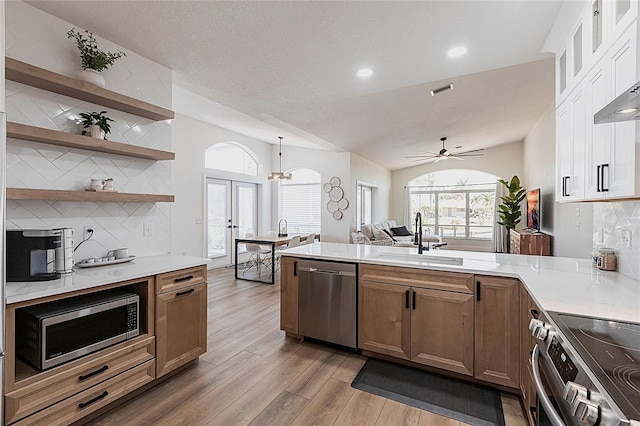 1711 Boca Raton Ct, Punta Gorda, FL 33950 - kitchen featuring a sink, a peninsula, decorative backsplash, light countertops, and appliances with stainless steel finishes