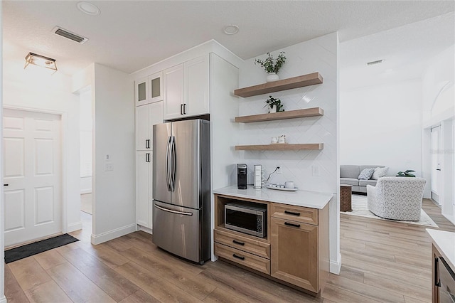 1711 Boca Raton Ct, Punta Gorda, FL 33950 - kitchen featuring light countertops, visible vents, light wood-style flooring, and appliances with stainless steel finishes