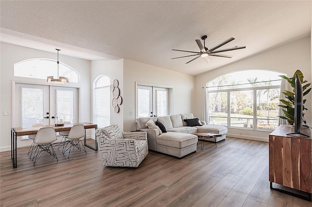1711 Boca Raton Ct, Punta Gorda, FL 33950 - living area with a ceiling fan, french doors, a textured ceiling, vaulted ceiling, and wood finished floors