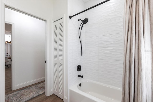 1711 Boca Raton Ct, Punta Gorda, FL 33950 - full bath featuring wood finished floors, a closet, baseboards, and shower / bath combo